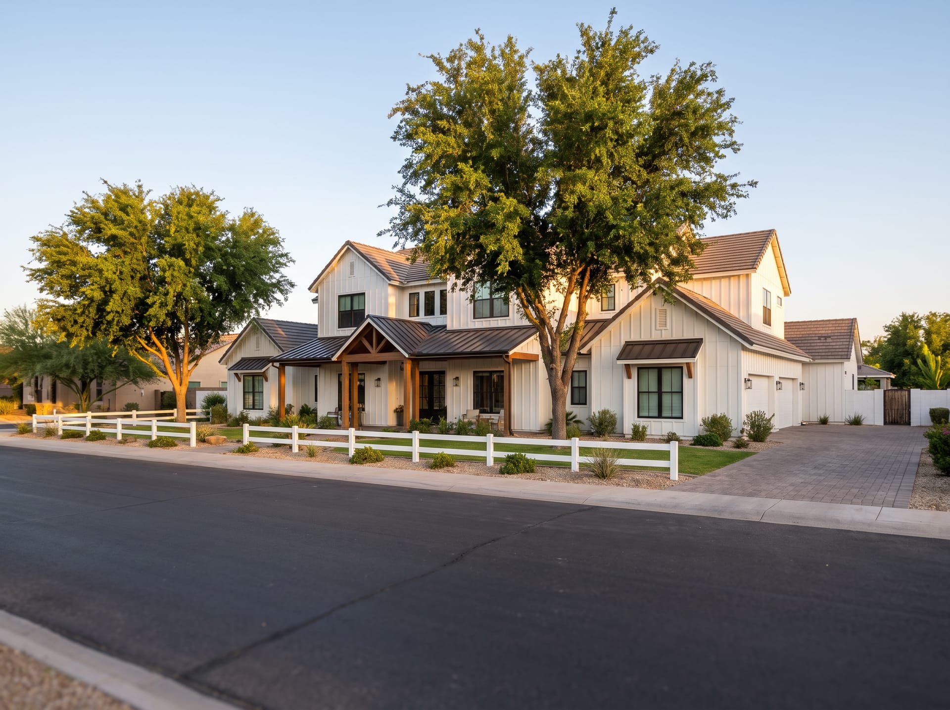 A modern farmhouse with a covered porch and rail fencing in Gilbert, Arizona